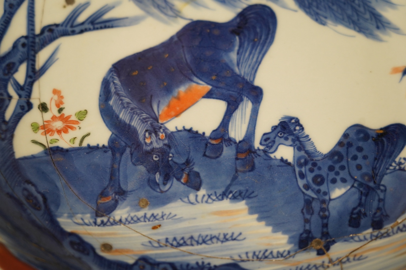 A Chinese underglaze blue and red and green enamelled 'horses' dish, Yongzheng period, 28.5cm. Condition - poor